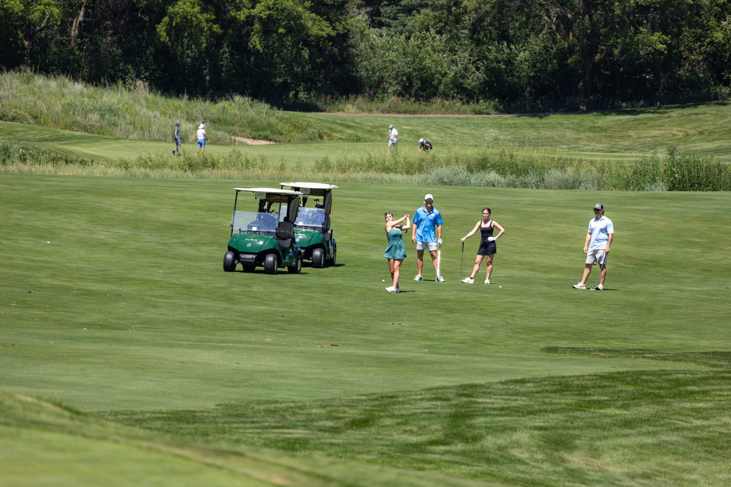 Golfers on the green at the Hazy Boy Open